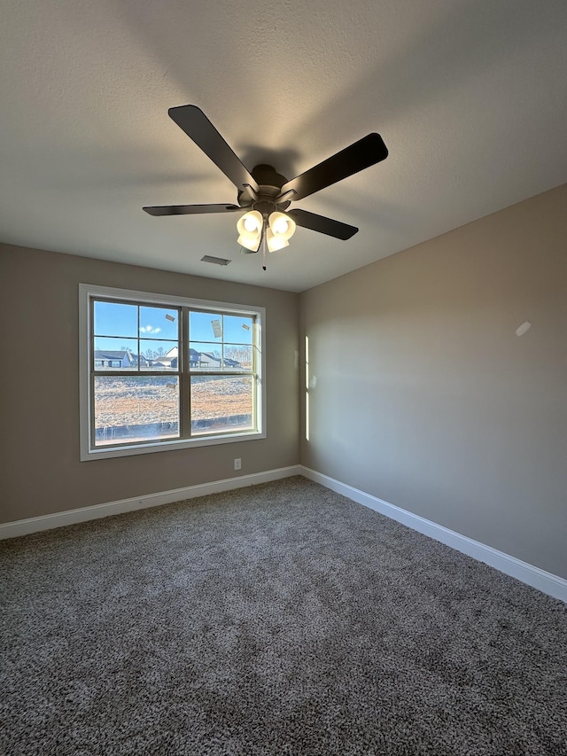 spare room featuring visible vents, a textured ceiling, baseboards, and carpet floors