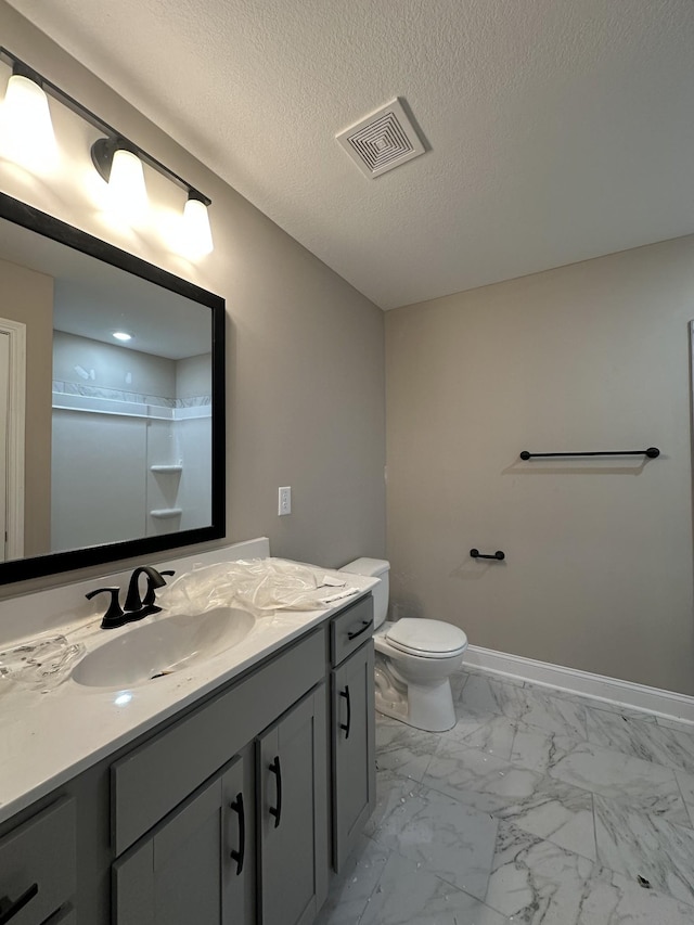 full bathroom with visible vents, toilet, marble finish floor, baseboards, and vanity