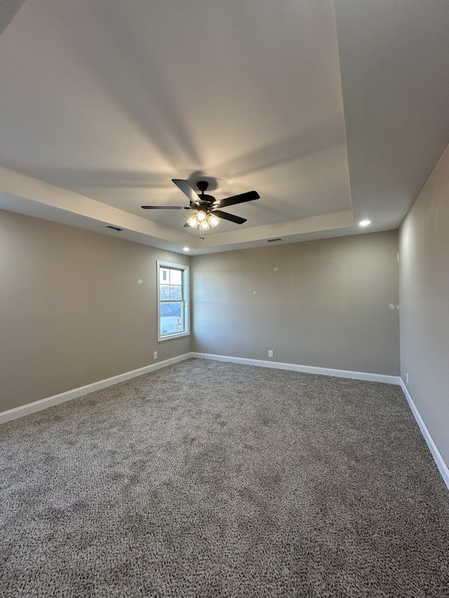 spare room with visible vents, baseboards, carpet floors, and ceiling fan