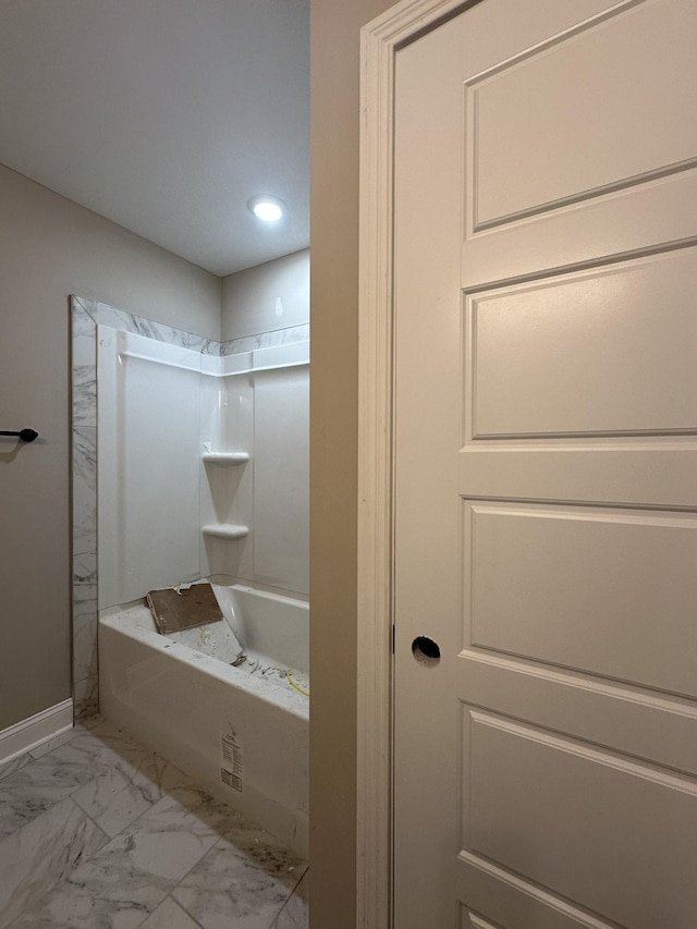 full bath featuring baseboards, marble finish floor, and shower / washtub combination