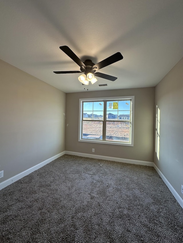 unfurnished room with visible vents, baseboards, carpet, and a ceiling fan