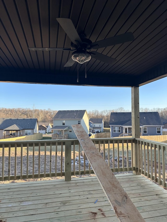 wooden terrace featuring a residential view and ceiling fan