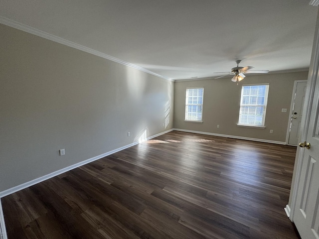 unfurnished room featuring dark wood-style floors, baseboards, ornamental molding, and a ceiling fan