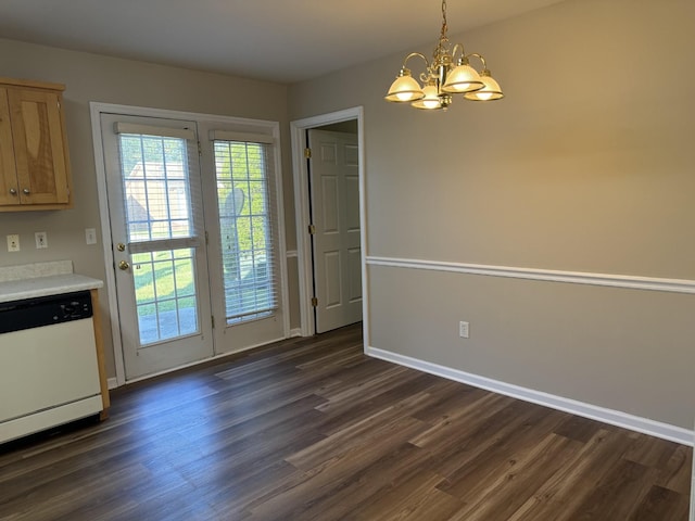 unfurnished dining area featuring a notable chandelier, baseboards, and dark wood finished floors