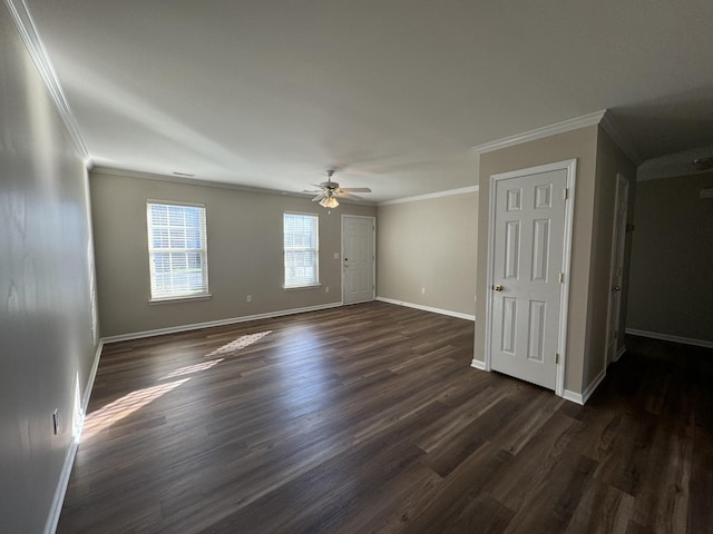 spare room with baseboards, dark wood-style floors, a ceiling fan, and crown molding
