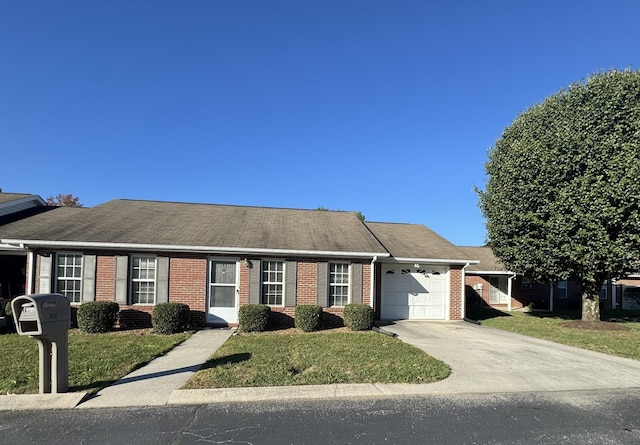 single story home featuring concrete driveway, a front yard, brick siding, and a garage