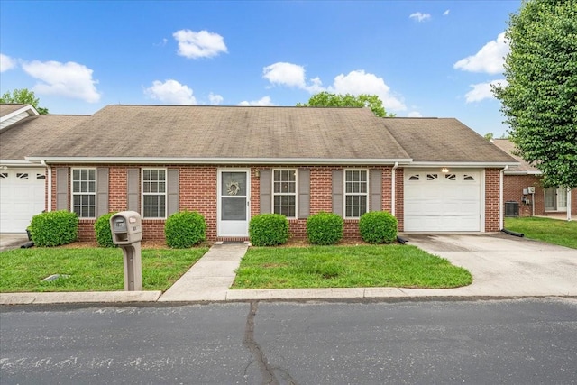 105 Middleton Ct, Tullahoma, TN 37388 - view of front of home with a garage, a front yard, brick siding, concrete driveway, and central air condition unit