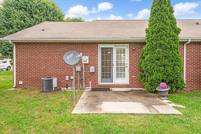 105 Middleton Ct, Tullahoma, TN 37388 - rear view of house with a lawn, brick siding, cooling unit, and a shingled roof