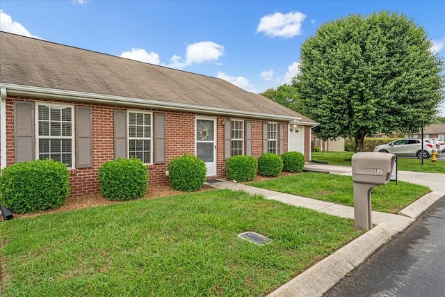 105 Middleton Ct, Tullahoma, TN 37388 - view of front of house featuring roof with shingles, an attached garage, a front yard, and brick siding
