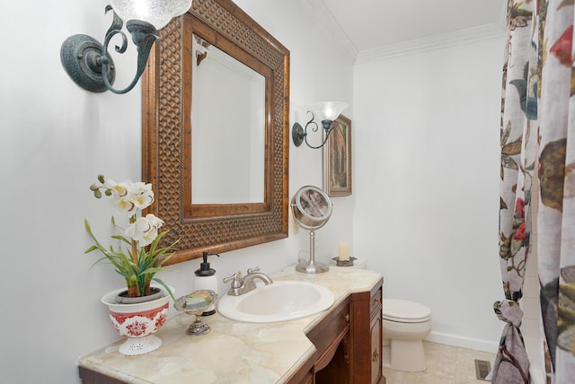 bathroom with vanity, crown molding, toilet, and tile patterned flooring