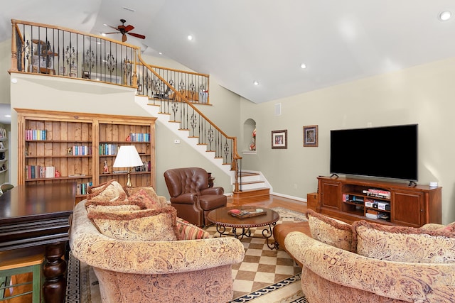 living room featuring hardwood / wood-style floors, high vaulted ceiling, and ceiling fan