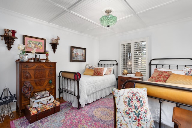 bedroom with crown molding and hardwood / wood-style flooring