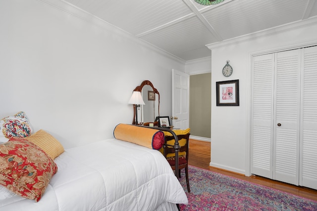 bedroom featuring ornamental molding, hardwood / wood-style floors, and a closet