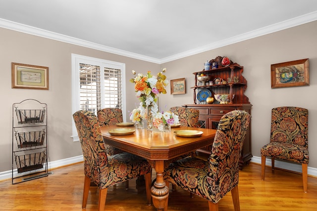 dining room featuring crown molding and light wood-type flooring