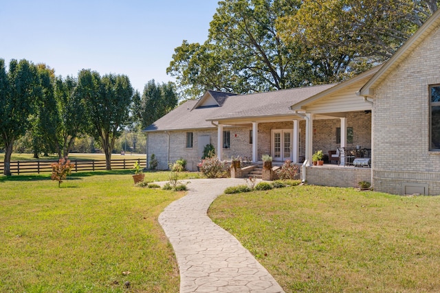 rear view of property featuring a patio area and a lawn