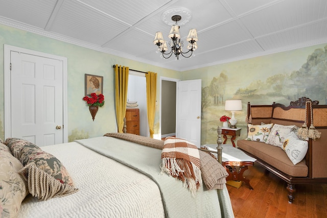 bedroom with ornamental molding, hardwood / wood-style flooring, and a chandelier