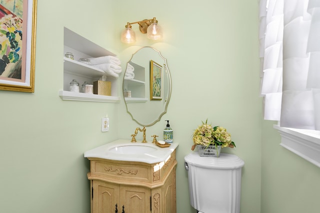 bathroom featuring toilet and vanity