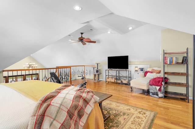 bedroom featuring lofted ceiling, a chandelier, and hardwood / wood-style flooring