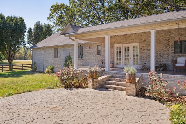 back of property featuring a yard and a patio area