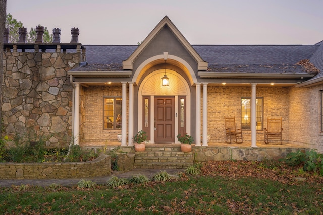 view of exterior entry at dusk