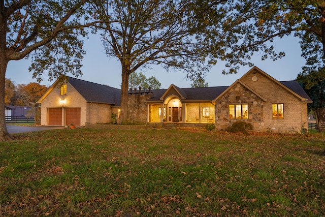 view of front of property featuring a yard and a garage