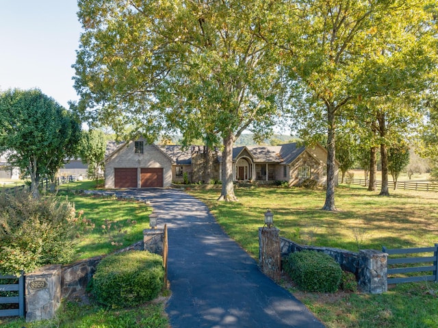 view of front facade featuring a front lawn and a garage