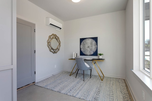 office area featuring a wall mounted air conditioner and concrete floors