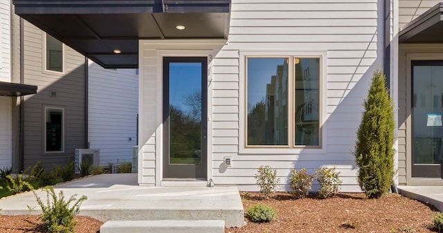 view of exterior entry featuring ac unit