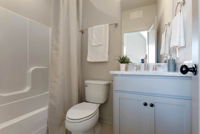 full bathroom featuring vanity, shower / bath combo, and toilet