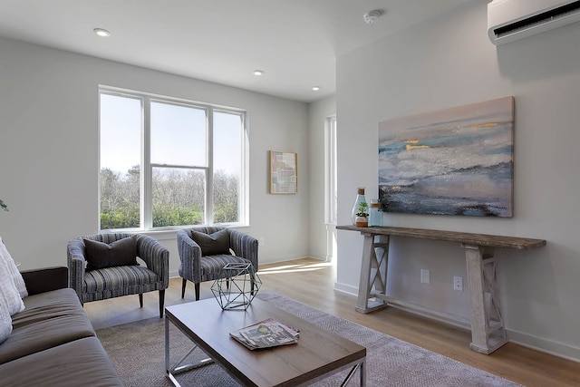 living room with light hardwood / wood-style flooring and a wall mounted AC