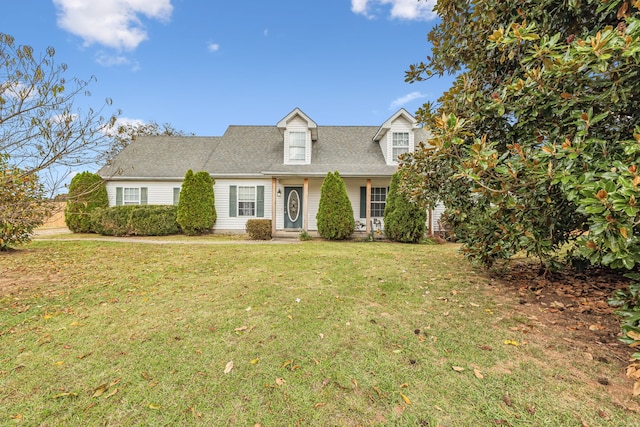 cape cod home with a front lawn