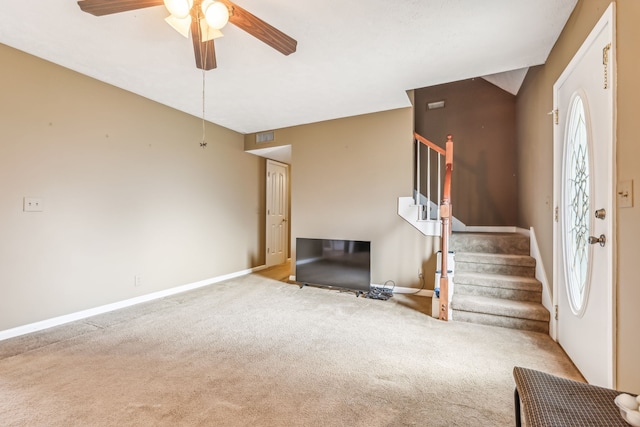 unfurnished living room featuring ceiling fan, light colored carpet, and a healthy amount of sunlight