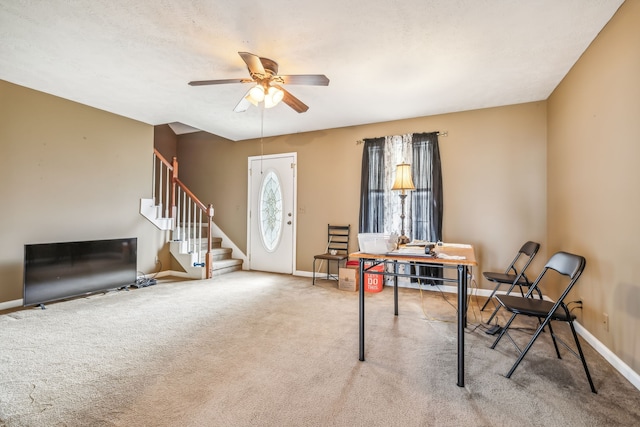 entrance foyer with carpet floors and ceiling fan