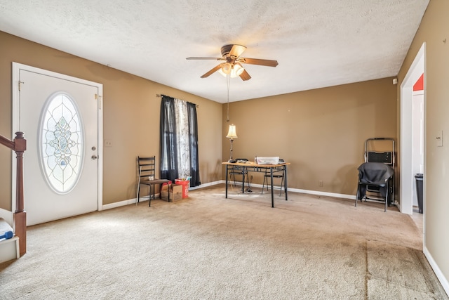 carpeted foyer entrance with ceiling fan and a textured ceiling