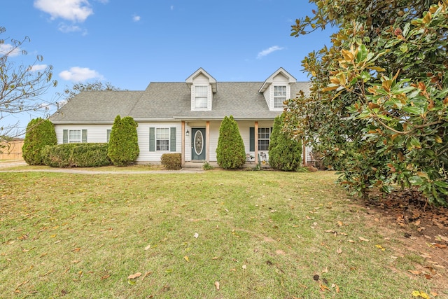 new england style home featuring a front yard