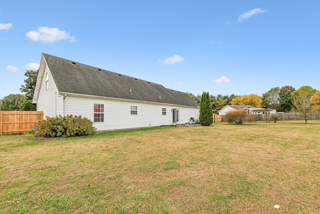 rear view of house with a yard