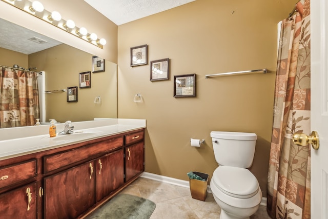 bathroom with tile patterned floors, vanity, toilet, and a textured ceiling