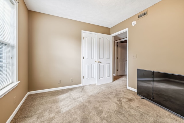 unfurnished bedroom with light carpet