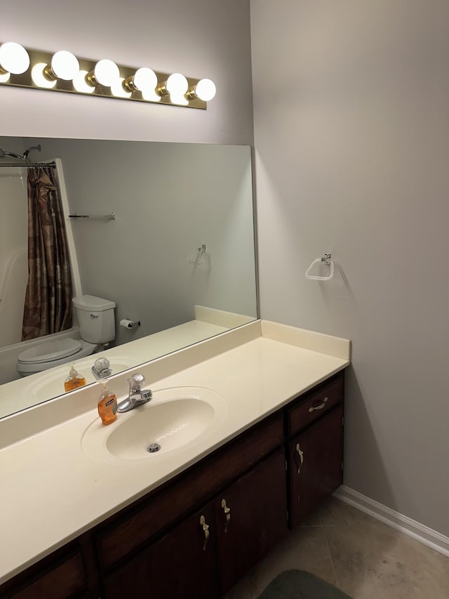 bathroom with tile patterned floors, toilet, and vanity