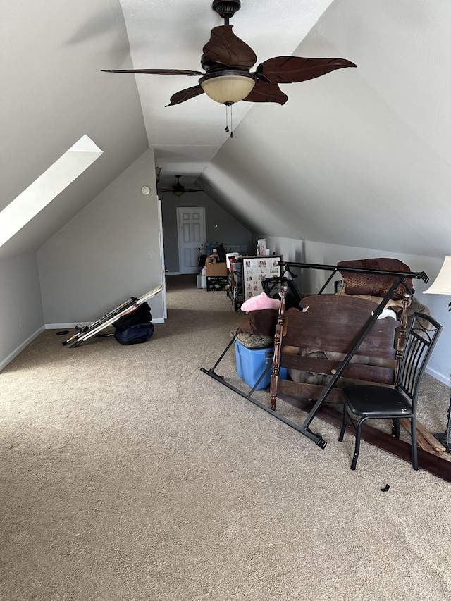 bonus room featuring ceiling fan, carpet flooring, and vaulted ceiling with skylight