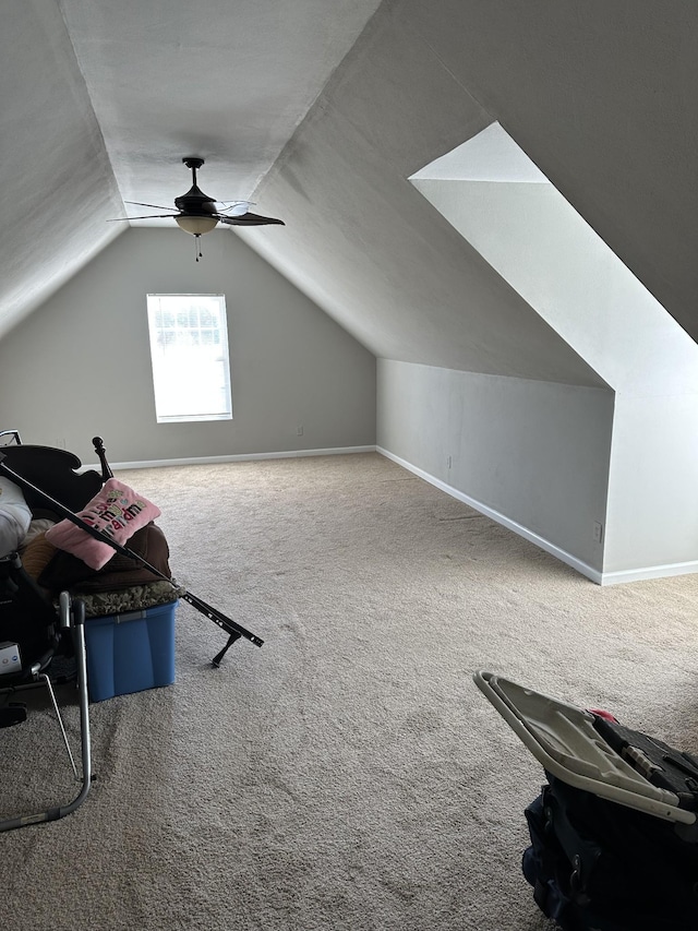 additional living space with carpet, lofted ceiling, and ceiling fan