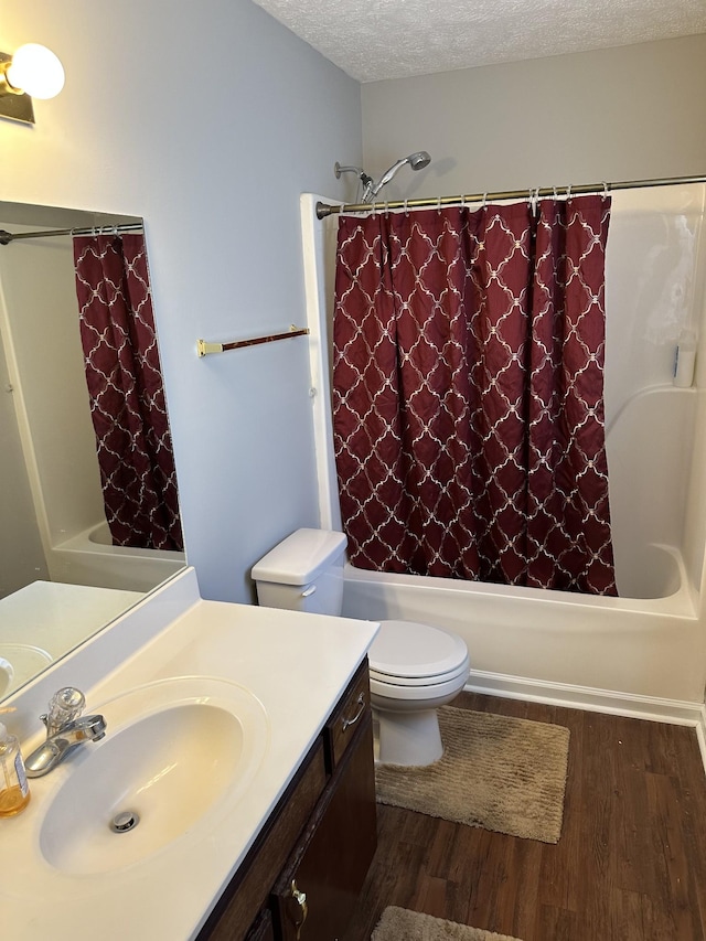 bathroom featuring hardwood / wood-style flooring, vanity, a textured ceiling, and toilet