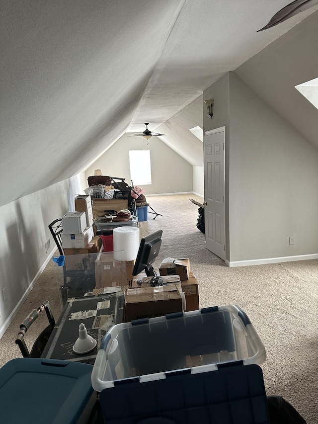 additional living space with vaulted ceiling, carpet, and ceiling fan