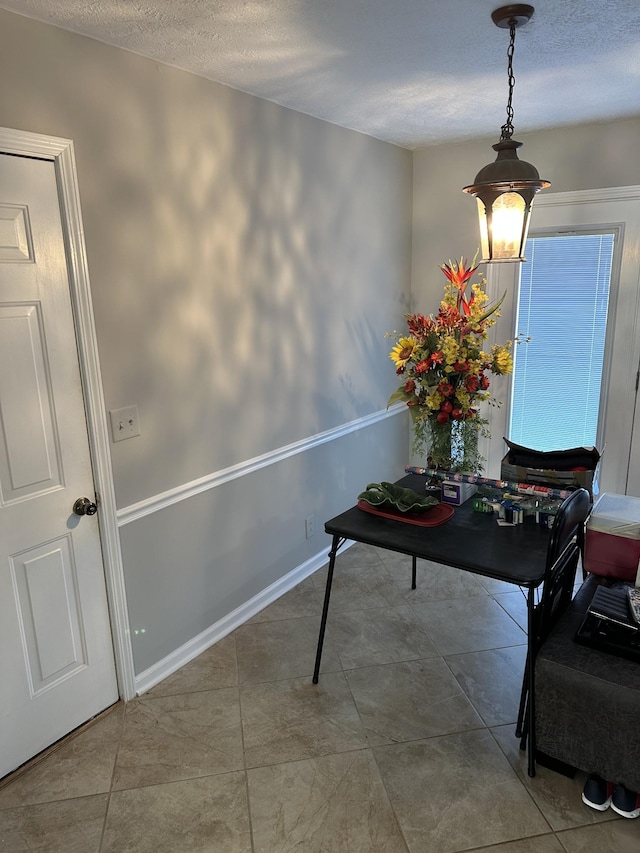 interior space with tile patterned floors and a textured ceiling