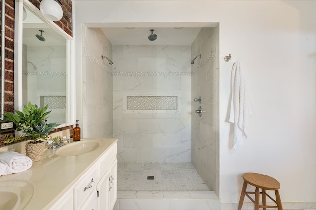 bathroom featuring vanity, tiled shower, and tile patterned flooring