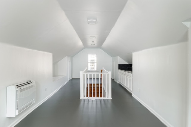 additional living space with heating unit and lofted ceiling