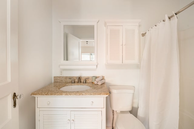 bathroom featuring vanity, toilet, and a shower with curtain