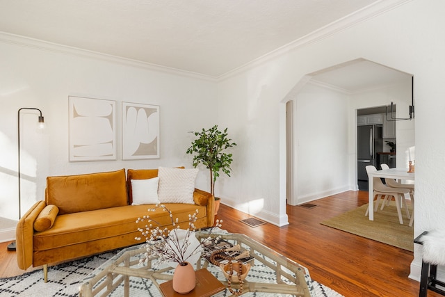 living room featuring crown molding and hardwood / wood-style floors