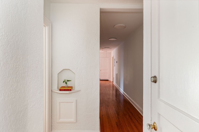 hallway with hardwood / wood-style floors