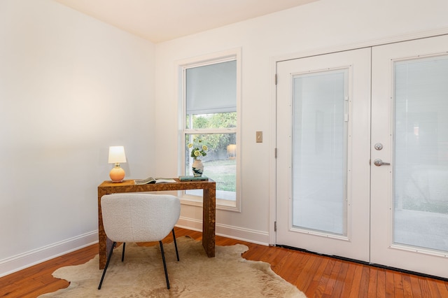 home office with french doors and hardwood / wood-style floors